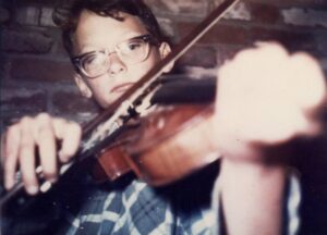 Young Phil Salazar playing violin
